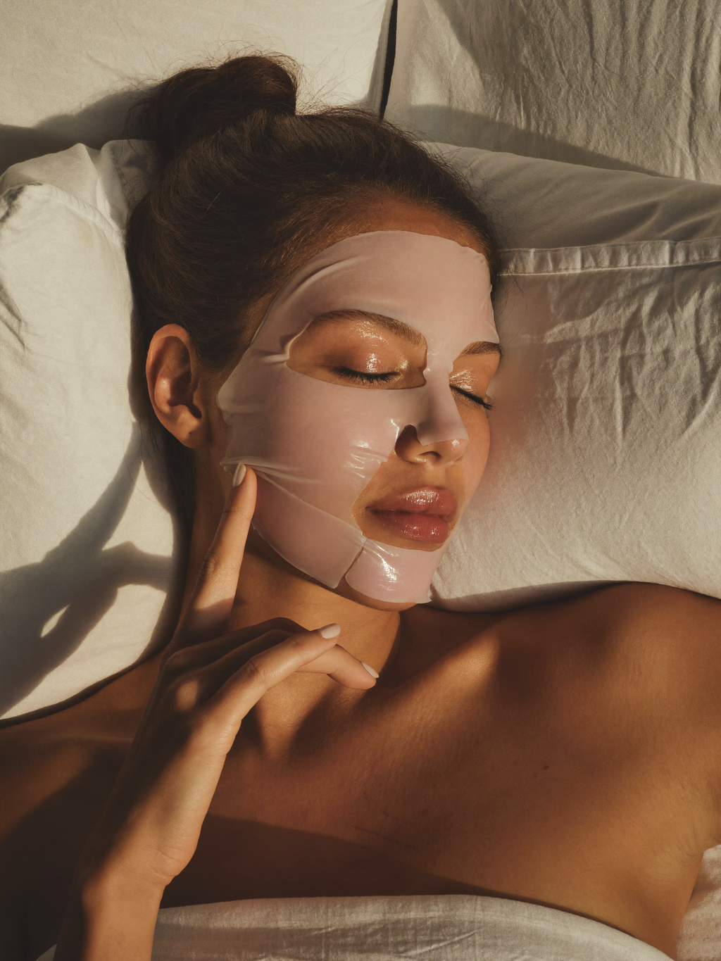 Woman relaxing with a bio-collagen overnight glow mask